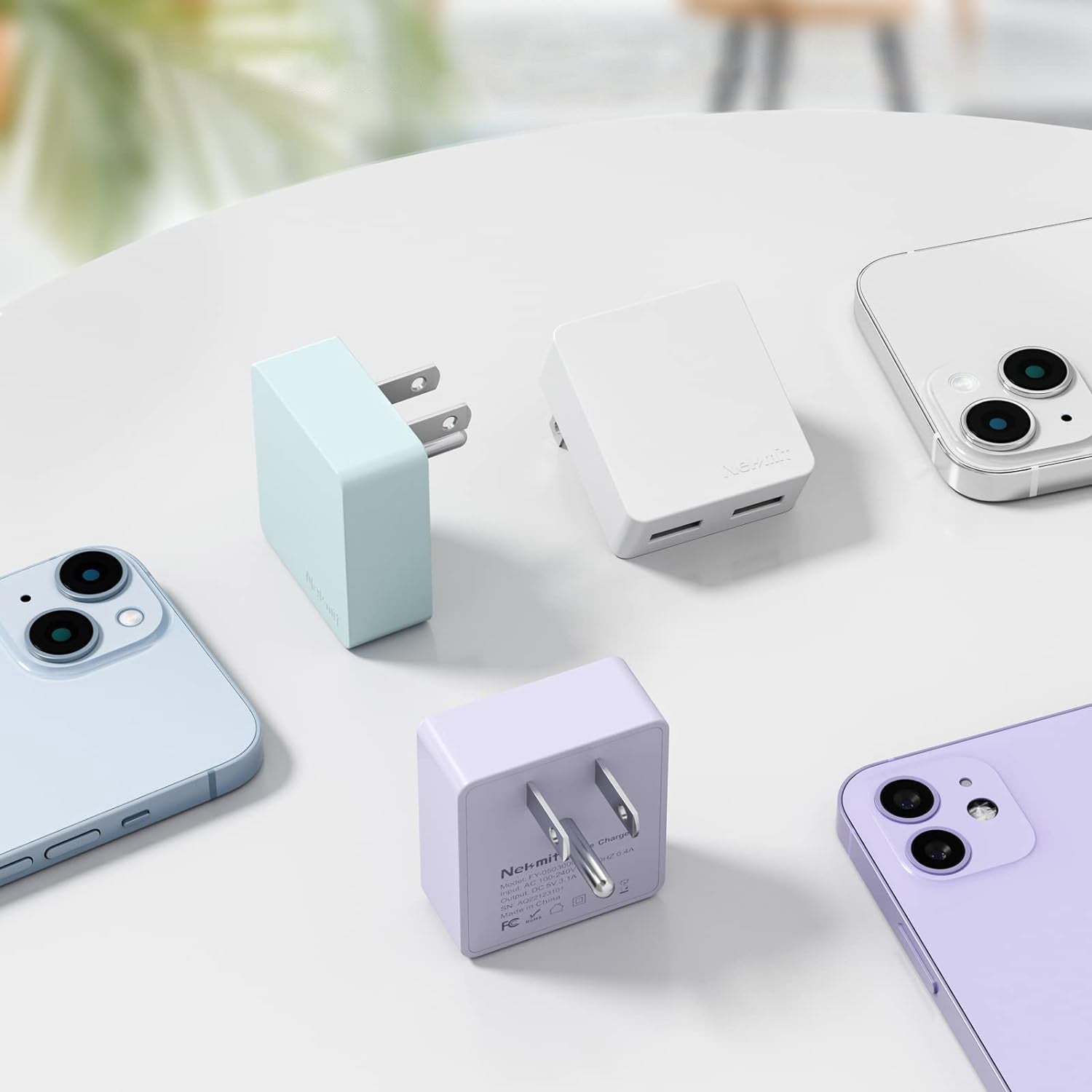 Smartphones and chargers on a light surface with a blurred background