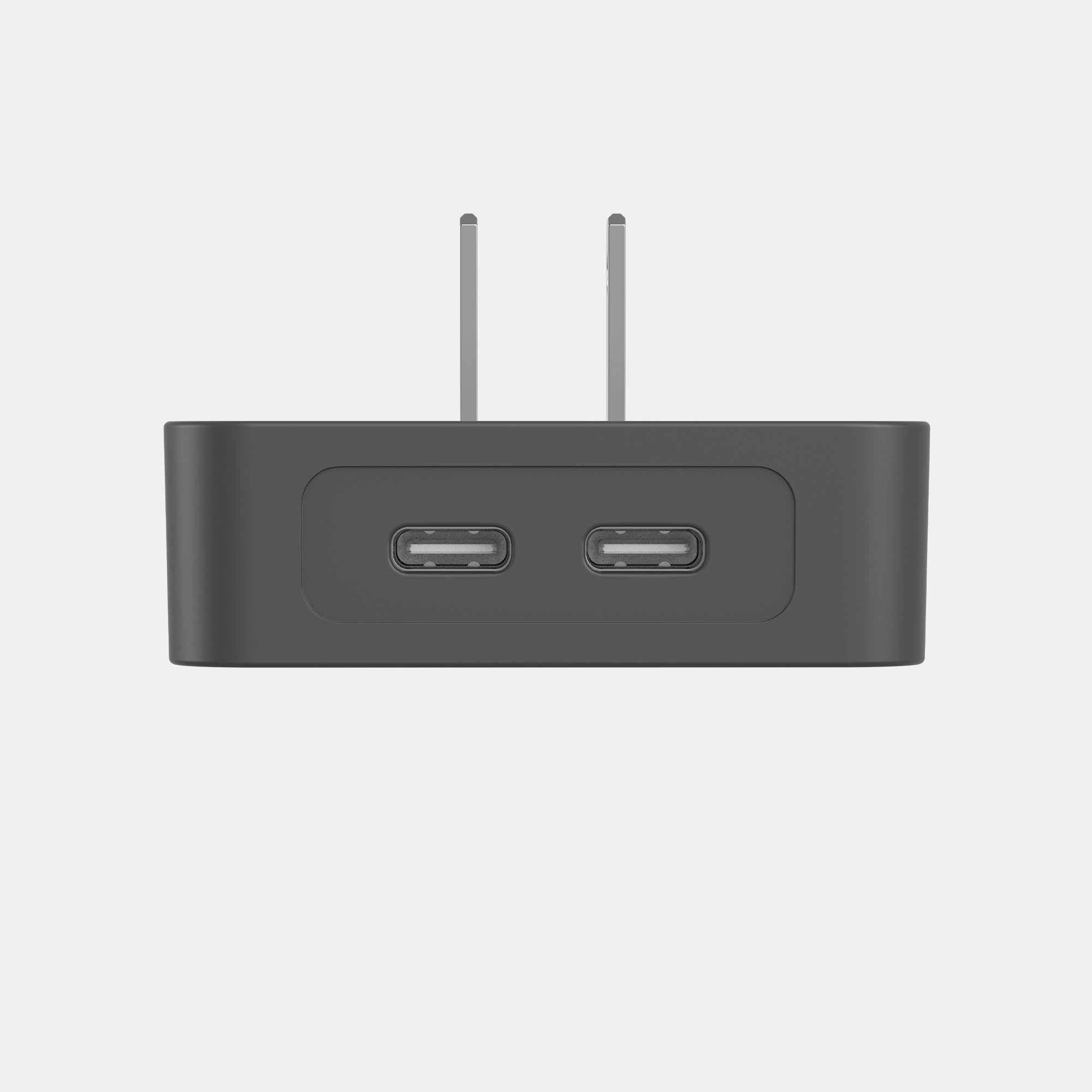Black electronic device with two USB ports and antennas on a light gray background