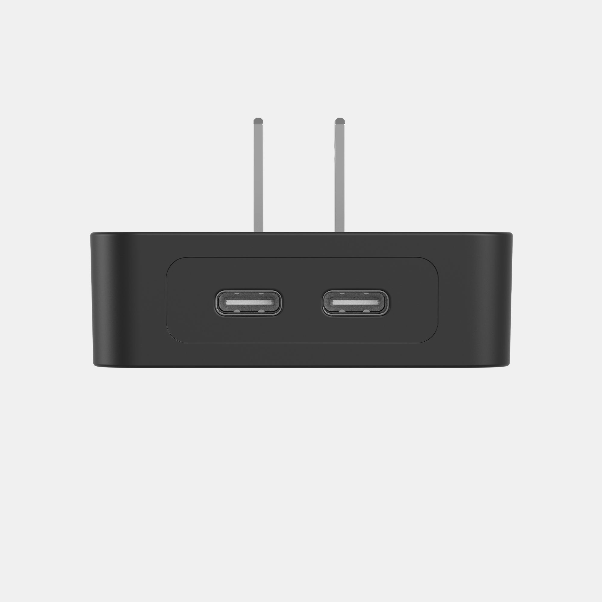 Black electronic device with two USB ports and antennas on a light gray background
