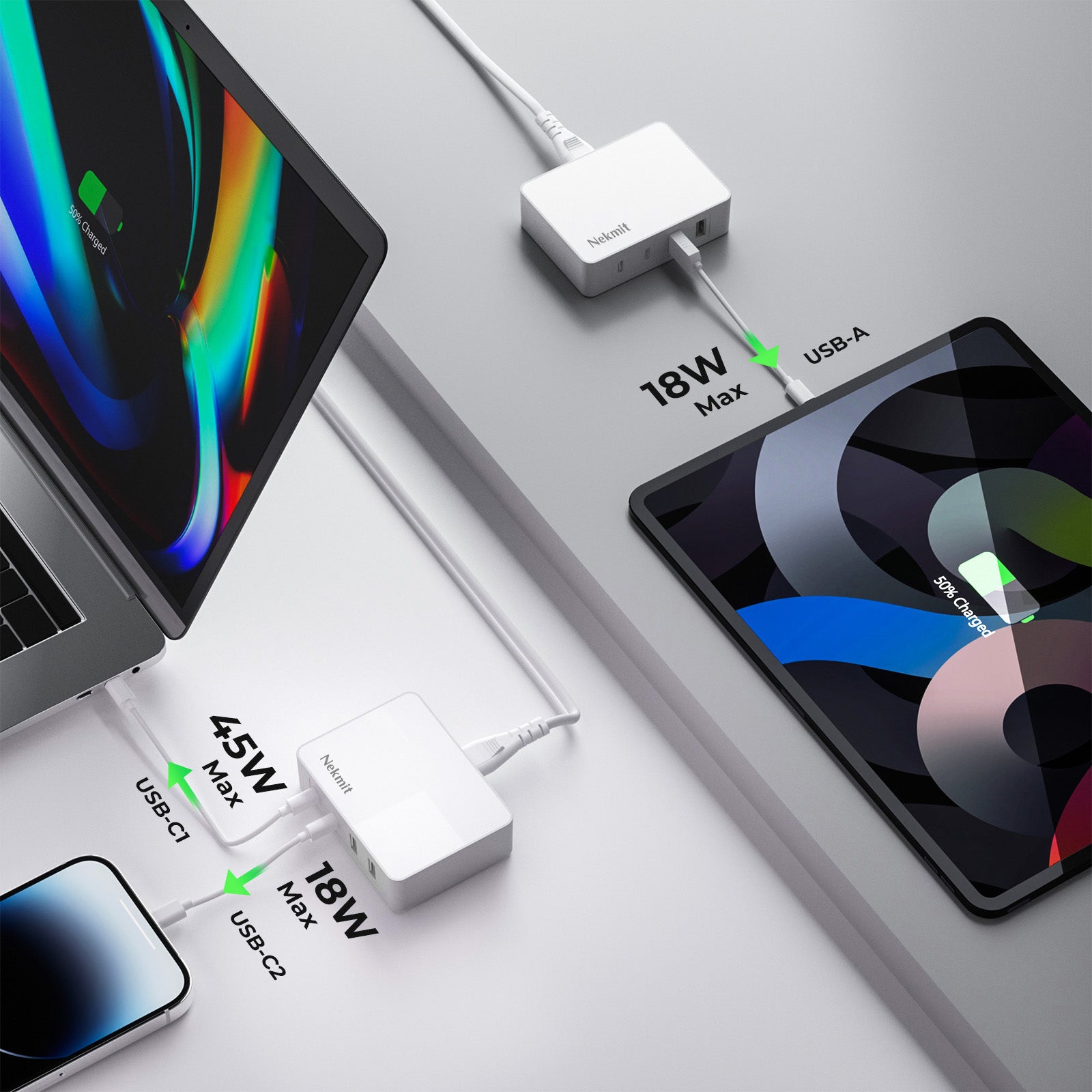 Multiple electronic devices connected to a power adapter on a light gray surface