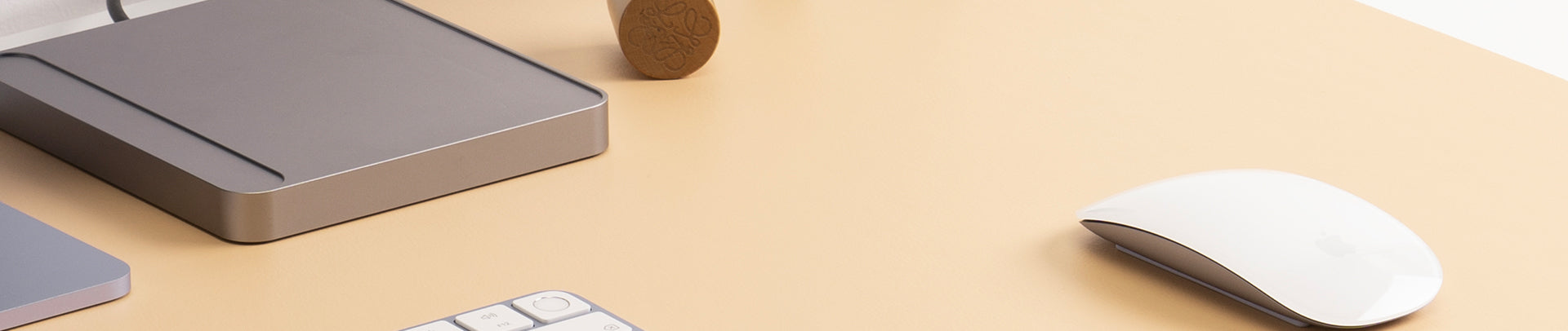 Computer mouse and keyboard on a beige desk
