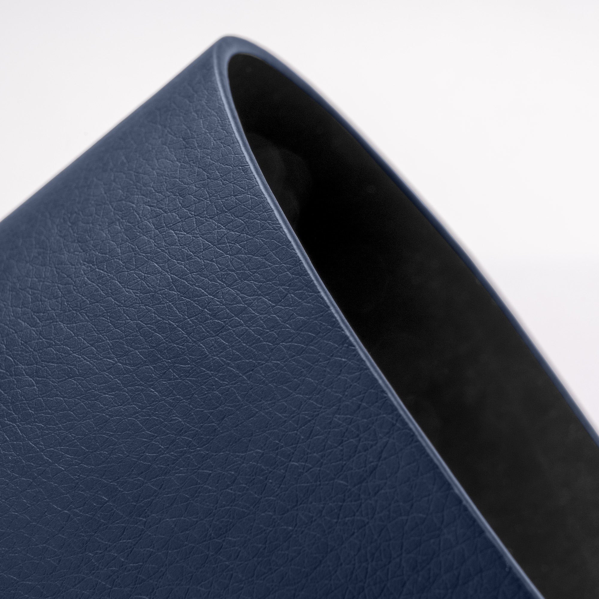 Close-up of a blue leather-bound book corner on a white background