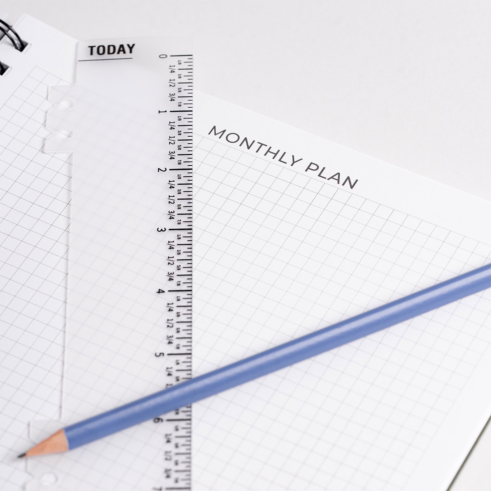 Monthly plan sheet with ruler and pencil on a white background