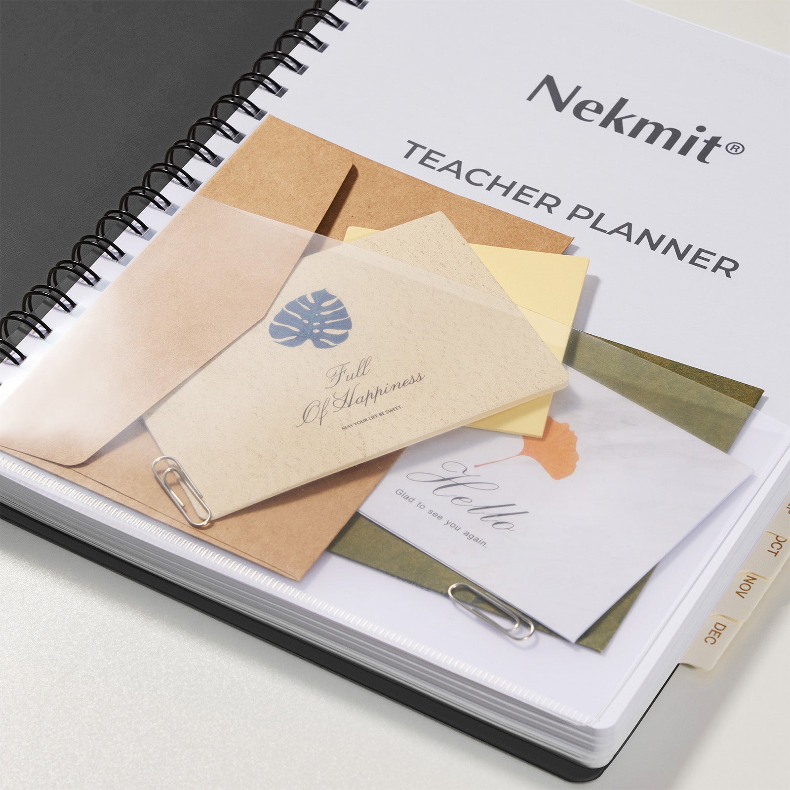 Teacher planner with stationery items on a white surface, featuring the brand 'Nekmit'.