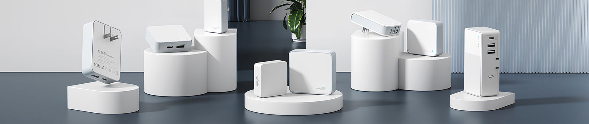 White electronic devices on stands against a light gray background