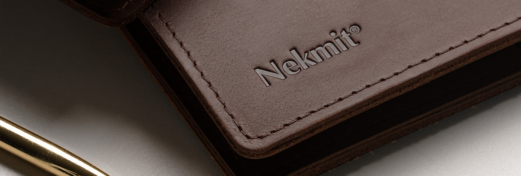 Brown leather wallet with 'Nekmit' branding on a light background