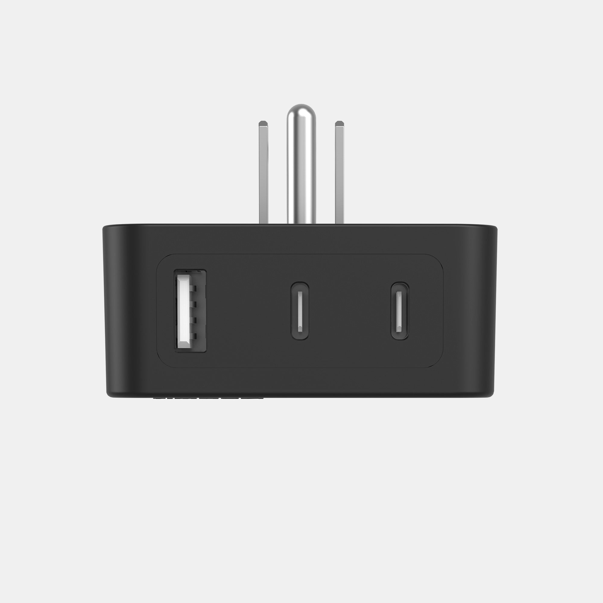 Black travel adapter with multiple ports on a light gray background
