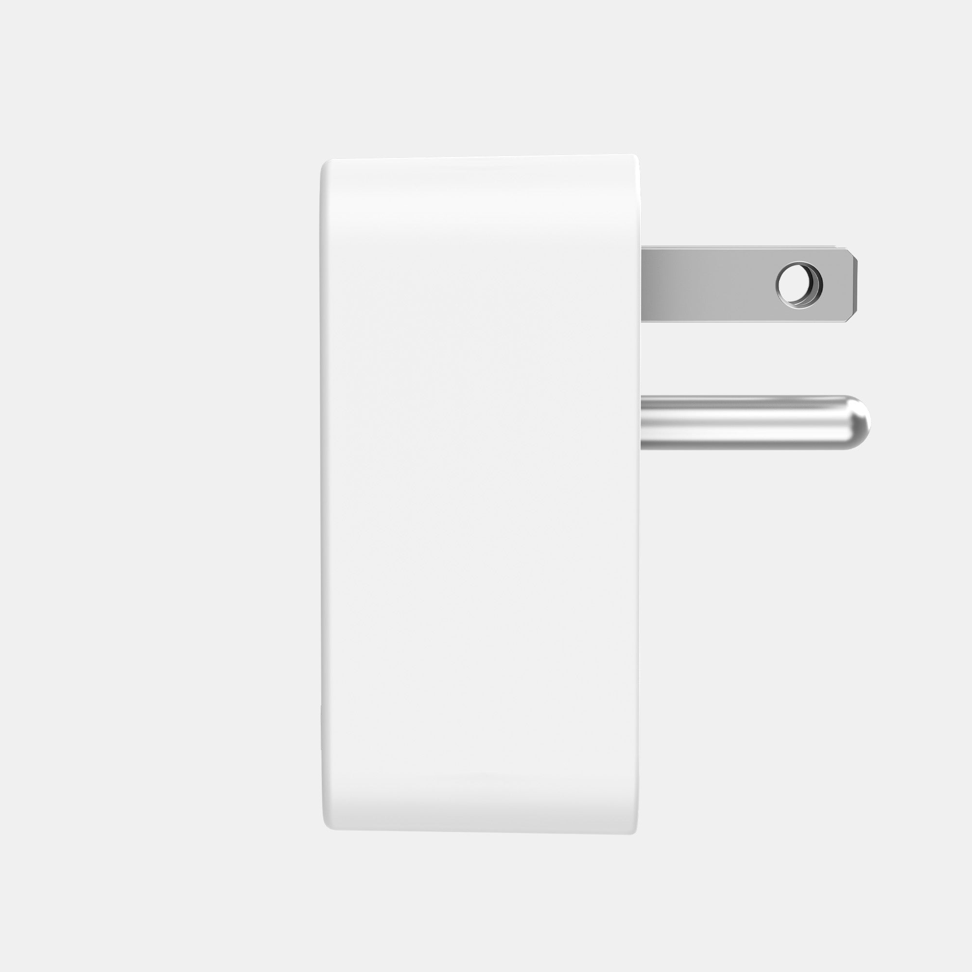 White rectangular object with metallic attachments on a light gray background