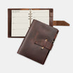 Brown leather planner with open pages on a white background