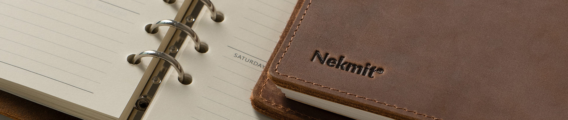 Brown notebook with 'Nelmit' branding on a white background