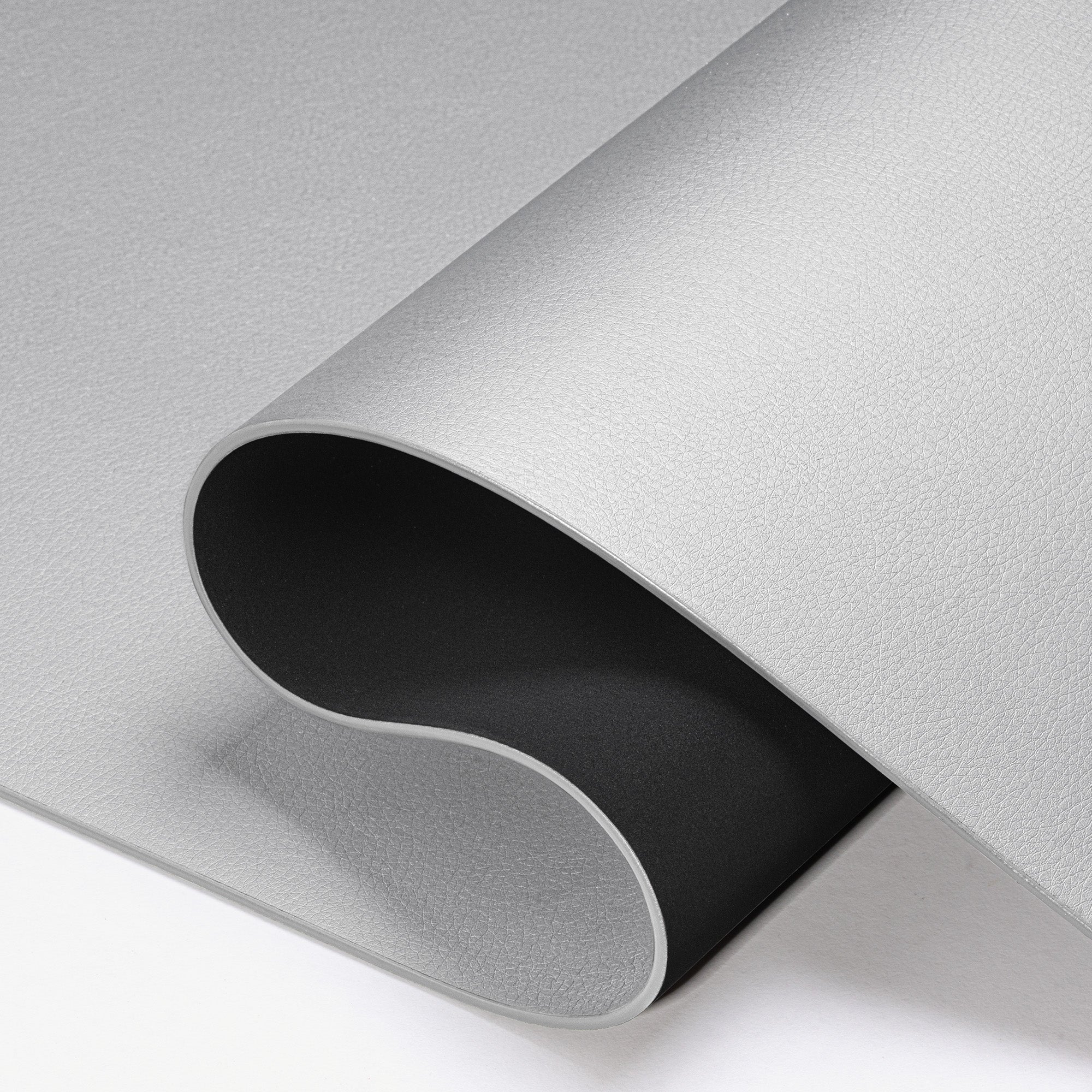 Roll of metallic silver paper on a white background