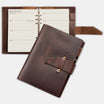 Brown leather planner with open pages on a white background